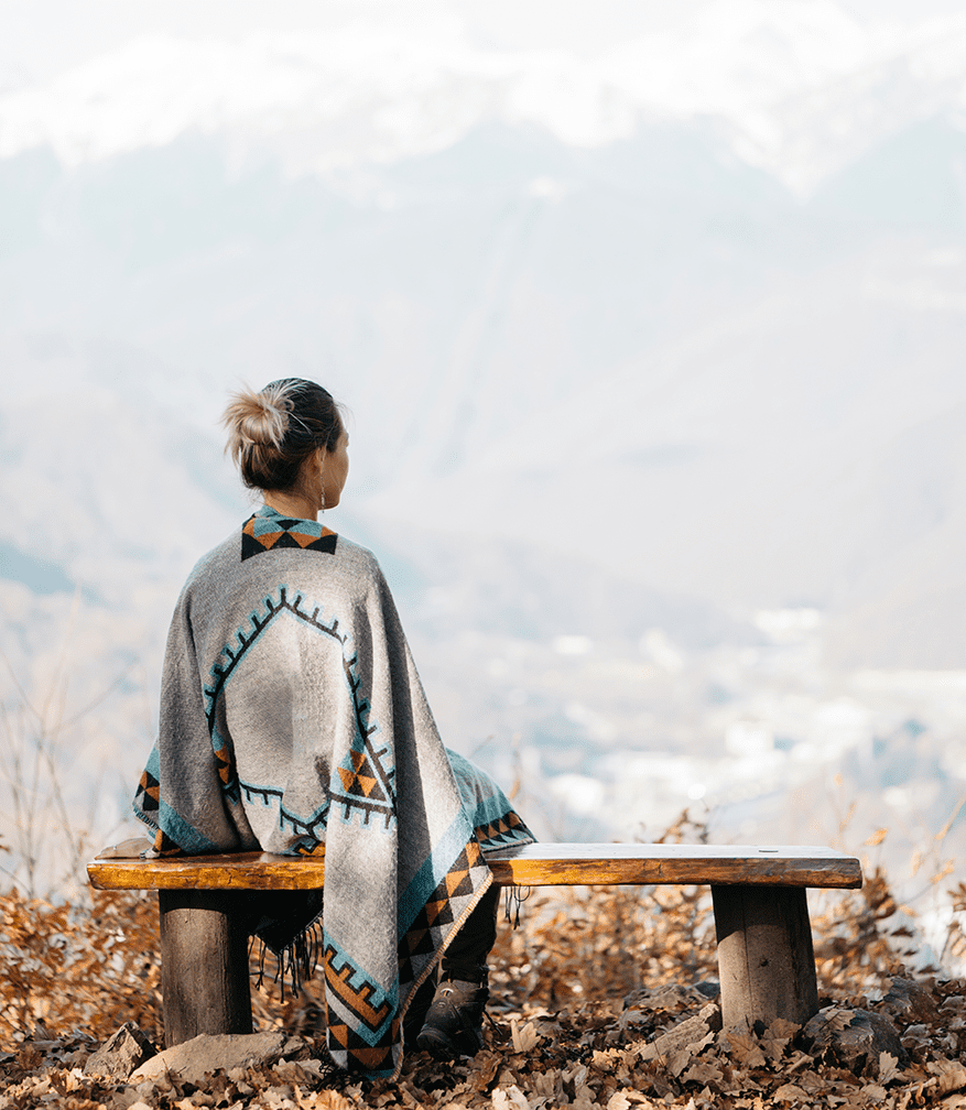 woman-resting-bench-front-mountains-3